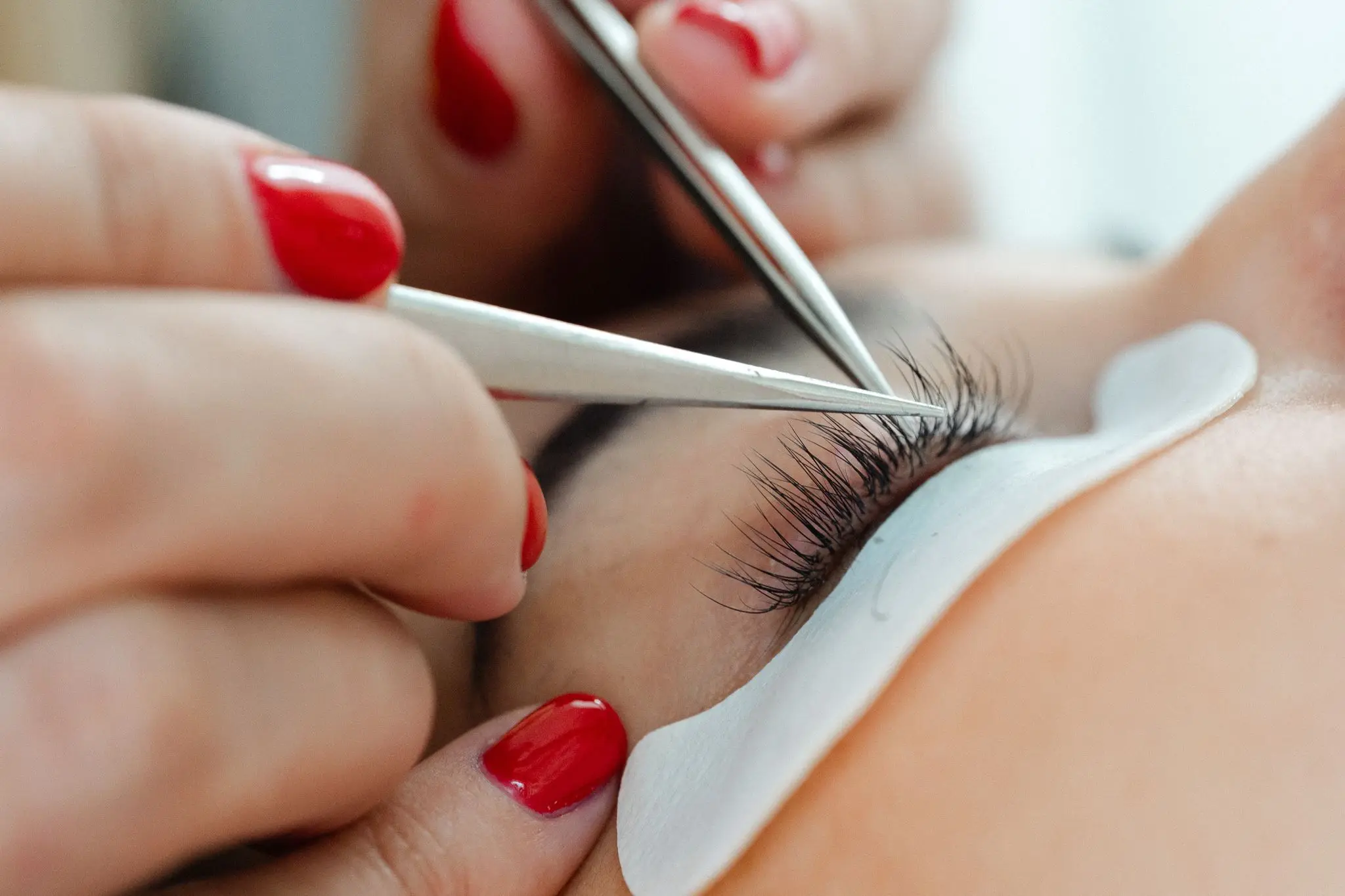 Close-up of lash extensions being applied