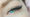 A woman with bright blue and slightly green/turquoise eyes with Cat eye styled lash extensions. The Cat eye eyelash extensions become thicker towards the outside of the eye.