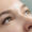 A woman with green eyes with natural looking eyelash extensions