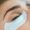 Close up of a woman with under eye padding on having eyelash extensions.