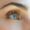 close up of natural looking eyelash extensions on a woman with blue eyes