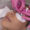 Close-up of a lash artist applying eyelash extensions with pink gloves during a professional treatment.
