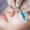 Close-up of a beauty treatment where a lash technician applies eyelash extensions to a client’s natural lashes using tweezers and pads.