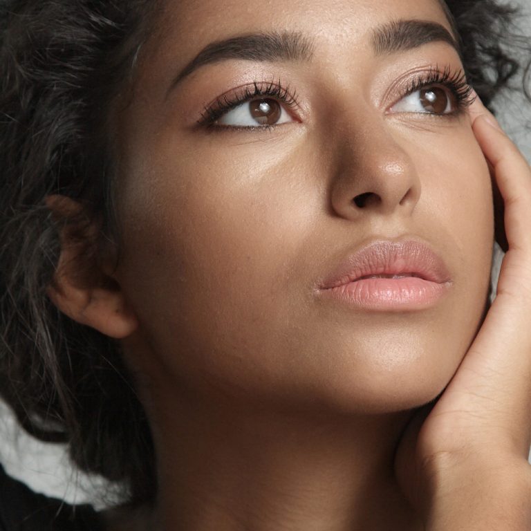 a model with natural eyelash extensions looking away from the camera