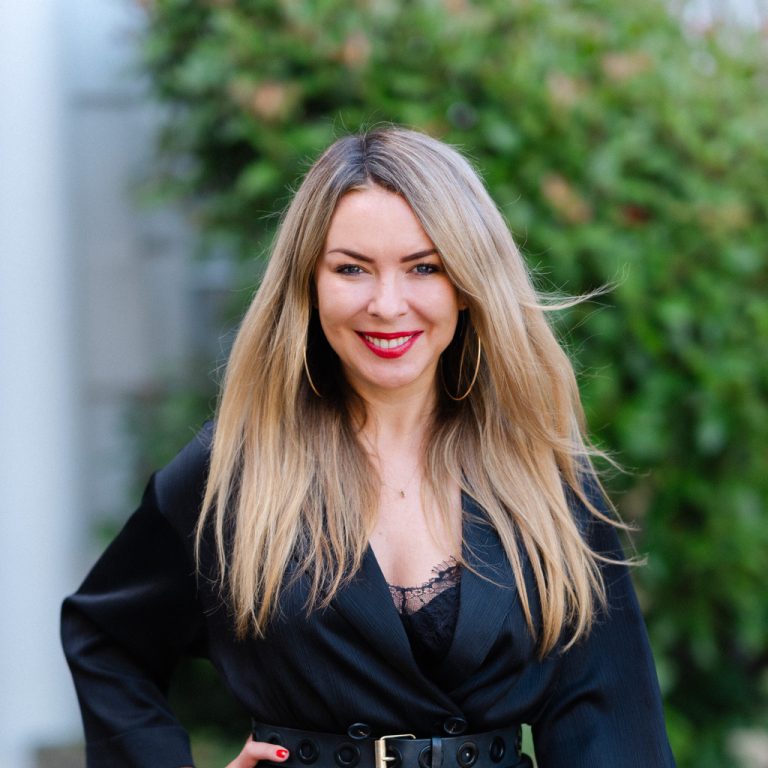 Edy from Edy London, considered one of the best lash extensions london, posing outside with natural looking eyelash extensions