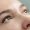 A woman with green eyes with natural looking eyelash extensions